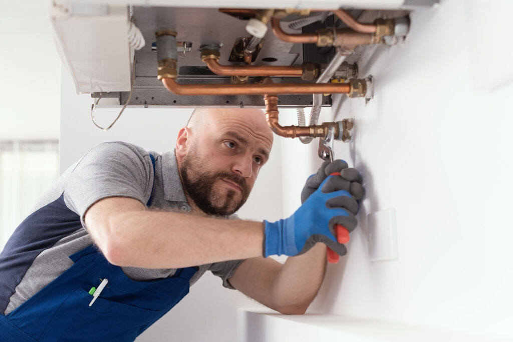 Gas engineer at work on boiler